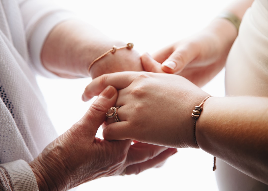 Caregiver holding the hand of an elderly loved one